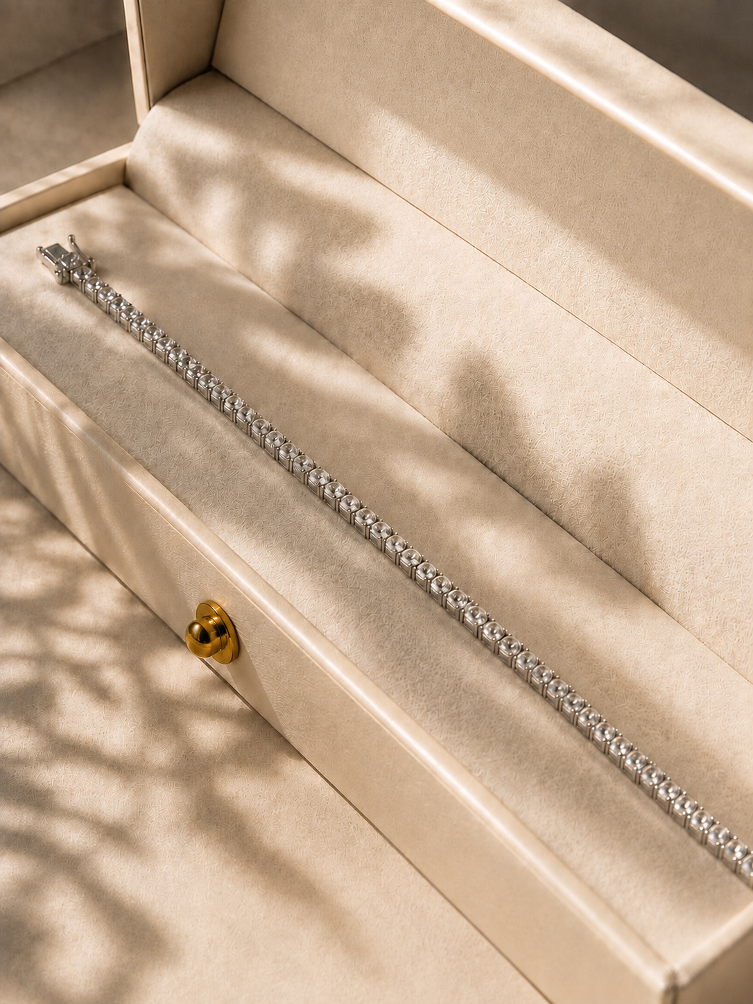 Noble Cut diamond tennis bracelet presented in a warm ivory jewelry case